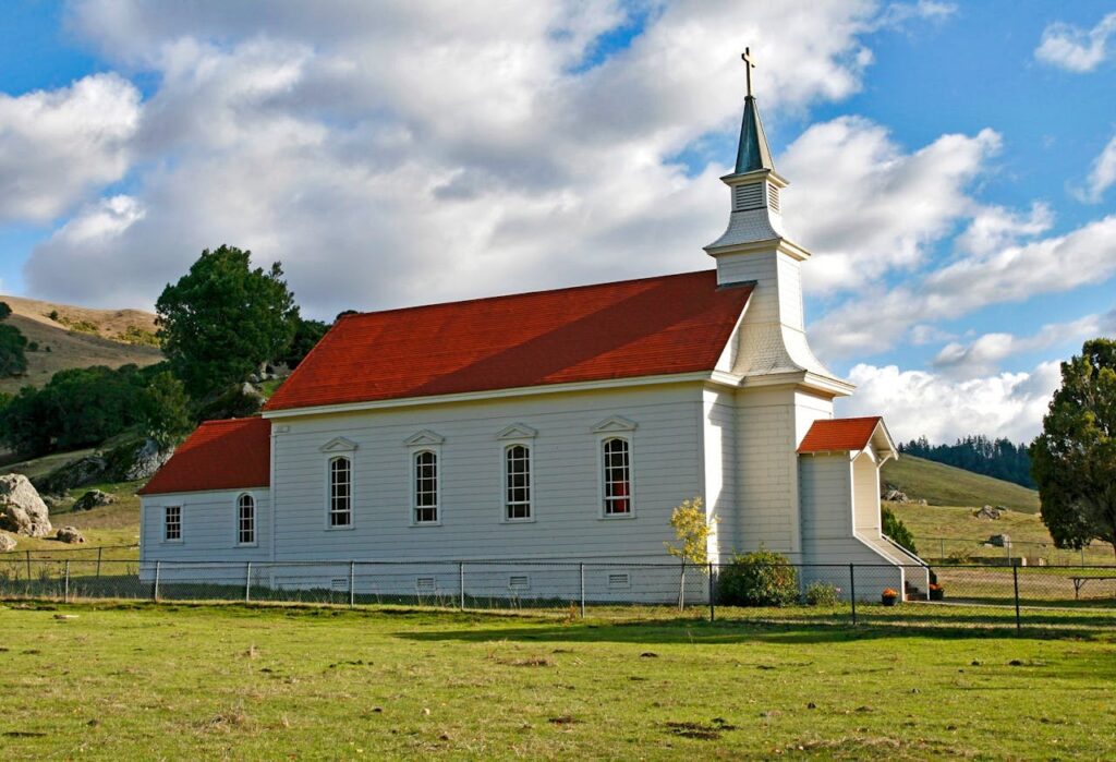 red-and-white-concrete-church-on-green-grass-field-208432 Red and White Concrete Church on Green Grass Field